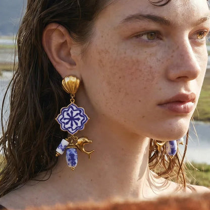 Woman wearing decorative earrings with a scenic background