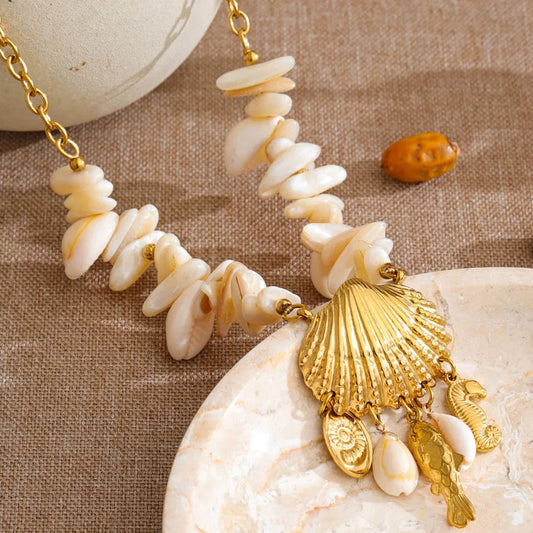 Necklace with shell and gold charm on a textured surface