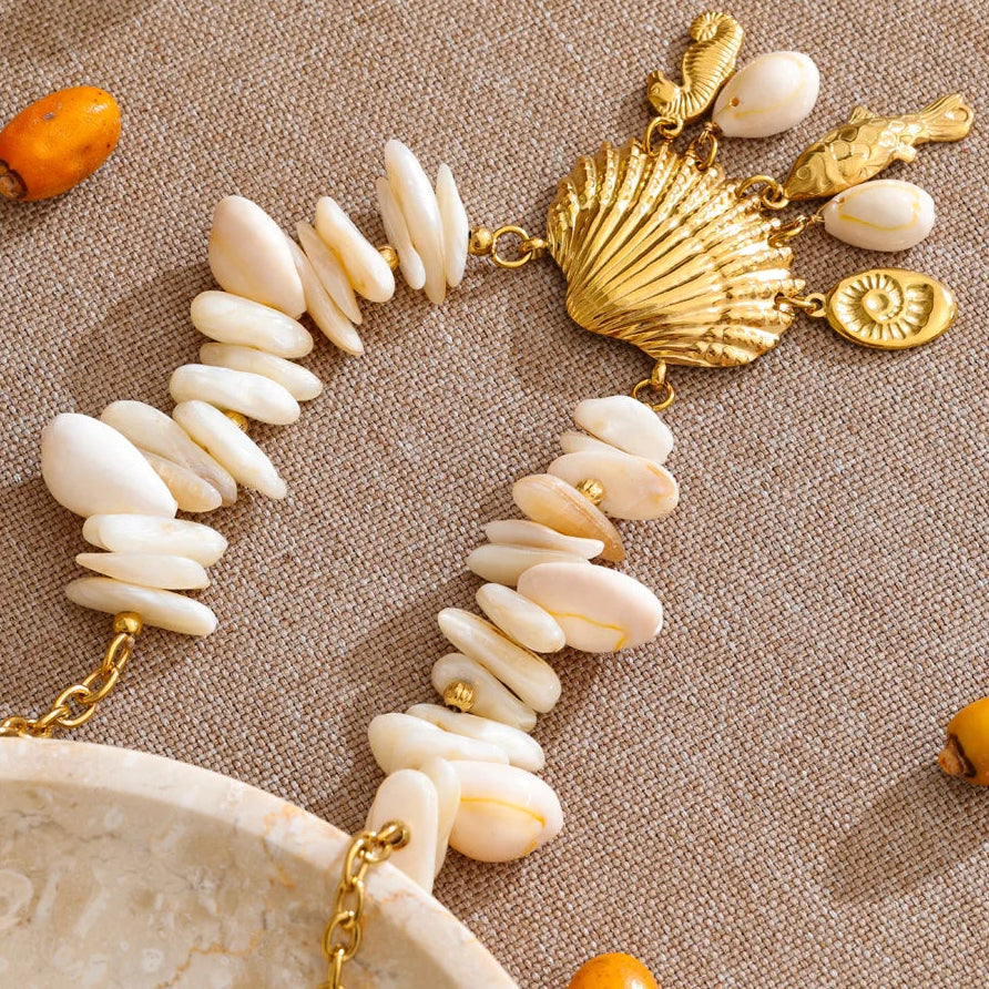 Necklace with white stones and gold accents on a beige background