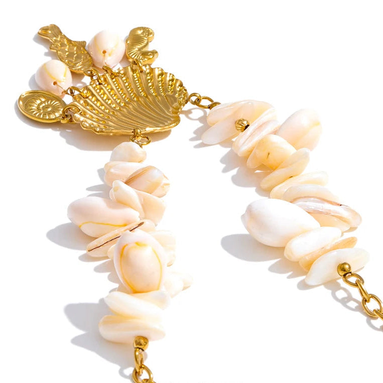 Necklace with gold clasp and shell-like beads on a white background