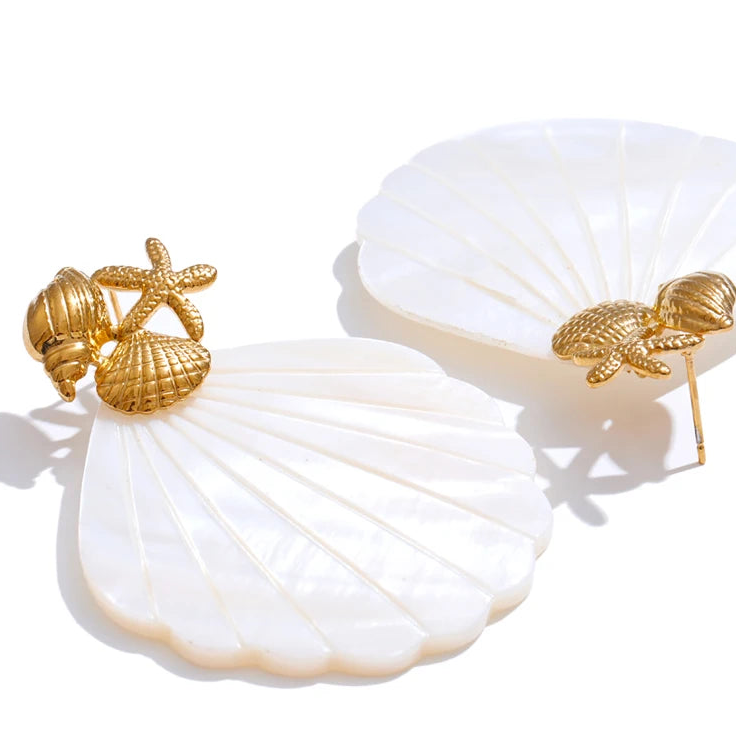 Gold starfish and shell earrings on white fabric with 'Physical Display' text.