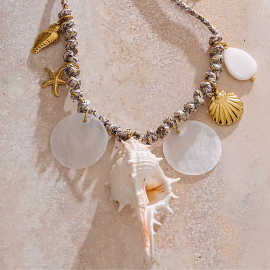 Necklace with natural conch and shell charms in 18K gold-plated stainless steel.