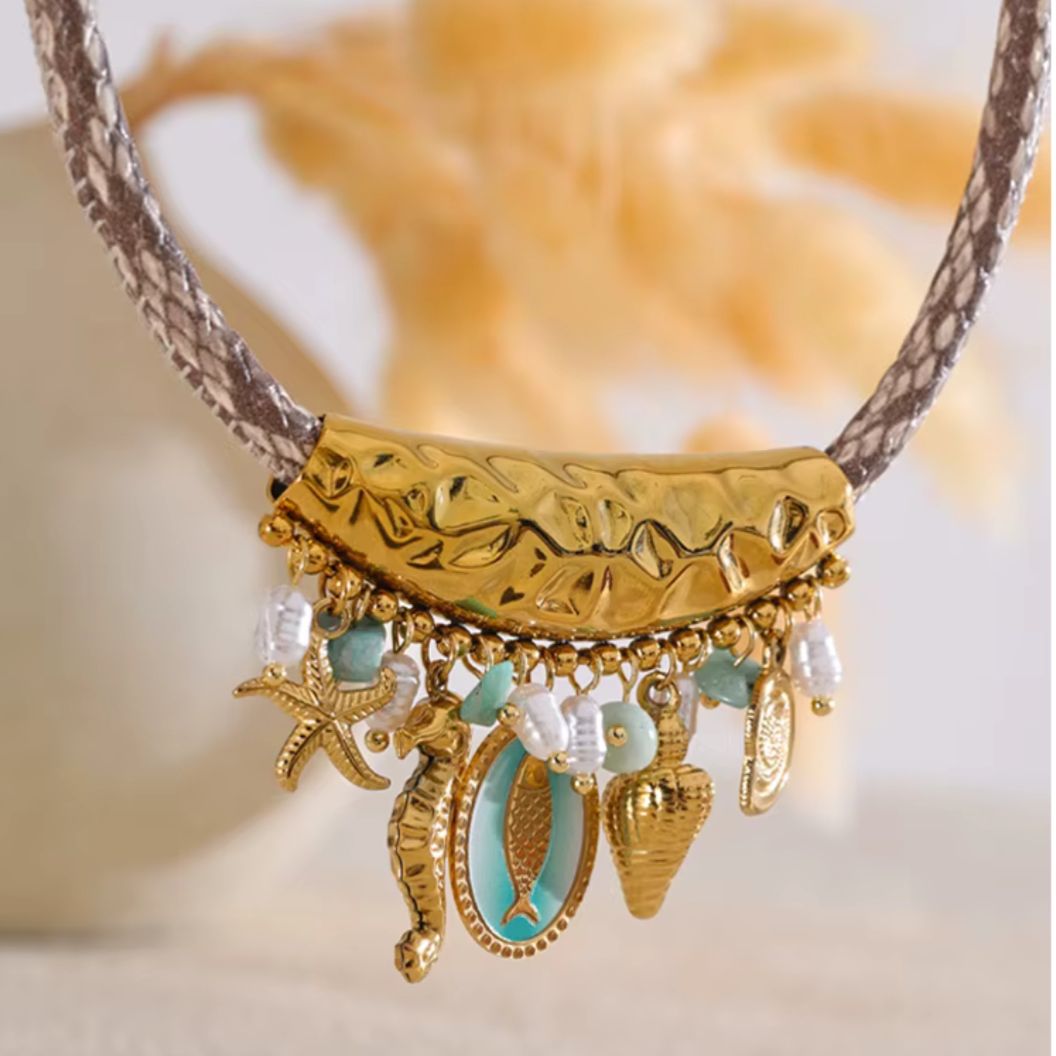 Handmade ocean-inspired drop necklace with pearls, starfish, and fish charms